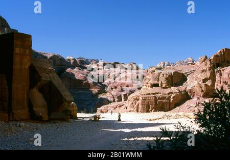 Jordanien: Die Straße der Fassaden mit Blick auf das Theater, Petra. Petra wurde im 4. Jahrhundert v. Chr. von den nabatäischen Arabern als Stadt gegründet und verdankt seine Geburt und seinen Wohlstand der Tatsache, dass es der einzige Ort mit klarem und reichlich Wasser zwischen den Hidschas-Handelszentren Mekka und Medina und Palästina war. Direkt in die nubischen Sandsteinkämme der südjordanischen Wüste gehauen, scheint es wahrscheinlich, dass Petra aufgrund seiner hervorragenden Verteidigungslage und der guten Wasserversorgung seit der paläolithischen Zeit fortwährend besetzt wurde. Stockfoto