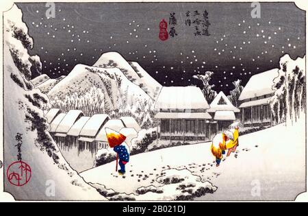 Japan: Station Fifteen: Abendschnee bei Kanbara. Ukiyo-e-Holzschnitt aus der Serie „Three Stations of the Tôkaidô Road“ von Utagawa Hiroshige (1797-1858), um 1834. Kambara: Ein Bergdorf bei Einbruch der Dunkelheit unter tiefem Schnee, durch das drei Menschen arbeiten, einer mit dem Kopf in einem halboffenen Regenschirm. Stockfoto