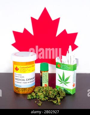 Cannabis in Kanada. Medizinisches Cannabis, Cannabisöl, Knospen und ein Paket Cannabiszigaretten auf einem Tisch, hinter dem ein kanadisches Ahorn-Blatt steht. Stockfoto