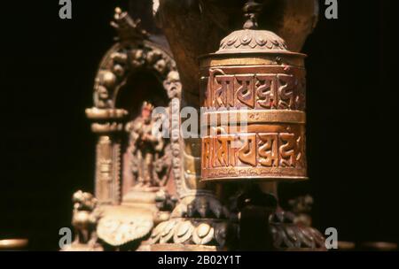 Nepal: Ein buddhistisches Gebetsrad im Goldenen Tempel (Hiranyavarna Mahavihara), Patan, Kathmandu-Tal (1998). Der Hiranyavarna Mahavihara oder Goldene Tempel ist eine der wichtigsten Kunst- und Architekturausstellungen im Kathmandu-Tal. Angeblich im 12. Jahrhundert von König Bhaskara Deva Varma gegründet, geht der Tempel, wie er sich heute darstellt, größtenteils auf das 18. Jahrhundert zurück. Die gesamte Fassade des Hauptschreins ist mit vergoldetem Kupfer bedeckt, ebenso wie die sehr detaillierten Toranen und alle Dächer. Stockfoto