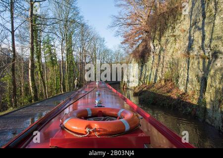 Blick von einem schmalen Boot aus, das in der ländlichen Landschaft auf dem britischen Wasserstraßenkanal unterwegs ist Stockfoto