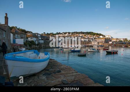 Kleine Erholungs- und Fischerboote werden innerhalb der Wellenbrücke im Hafen von Mousehole in Cornwall, England, gefestert. Stockfoto