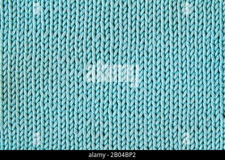 Türkis gestrickter strukturierter Hintergrund. Nahaufnahme Stockfoto