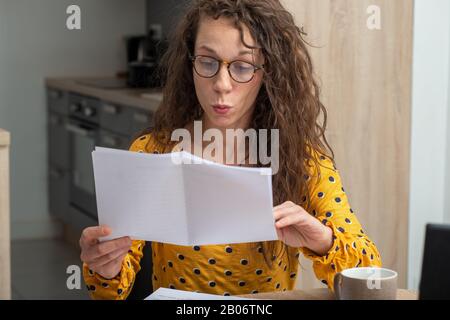 Eine junge Frau, die nach Hause schaut, erhielt Post Stockfoto