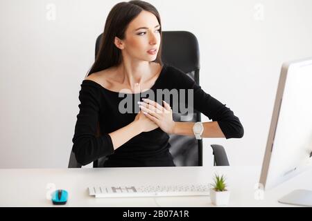 Herzschmerzen. Frau, die Panikattacke am Arbeitsplatz hat Stockfoto