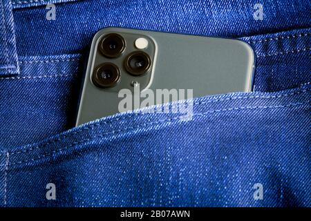 Neues Apple iPhone 11 Pro max Smartphone In der Jeans Tasche Nahaufnahme Detailansicht der Dreifach-Kamera. Stockfoto