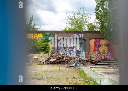 Berlin, Friedrichshain. Referenzen zu YAAM, Young African Art Market mit Wand in bunter Straßenkunst Stockfoto