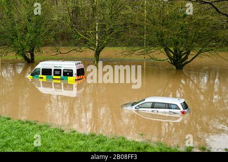 NANTGARW, IN DER NÄHE VON CARDIFF, WALES - FEBRUAR 2020: Auto und ein Rettungswagen, der in Sturmwasser eingetaucht ist, nachdem der Fluss Taff seine Ufer in der Nähe von Cardiff platzte. Stockfoto