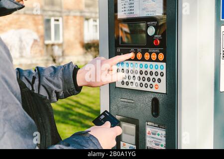 Zahlung für Parkplätze in der Stadt Danzig, Polen am 8. Februar 2020. Eine Person nutzt Monobank Kreditkarte für nfc-Zahlung im Parkterminal. Bezahlt Stockfoto
