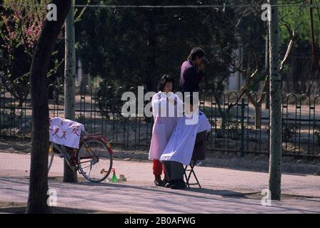 CHINA, PEKING, STRASSENSZENE, BARBER Stockfoto