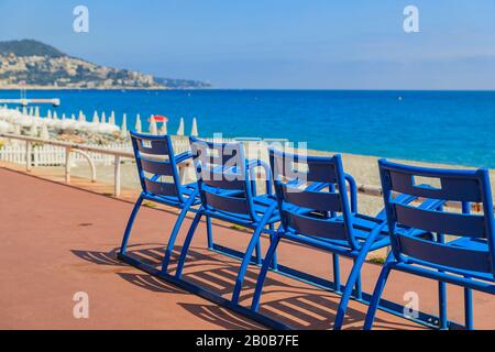 Mittelmeer und die berühmten Blauen chais an der Promenade des Anglais bei Sonnenuntergang in Nizza, Côte d'Azur, Frankreich Stockfoto