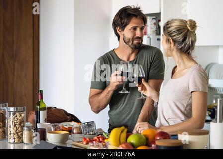 Paar, toasten Wein Gläser in Küche Stockfoto