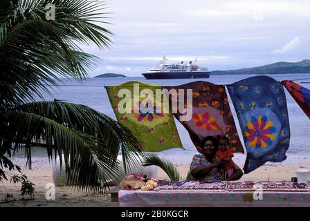 FIJI, YASAWA-GRUPPE, SAWA-I-LAU INSEL, BUNTES GEWEBE (PAREOS (BATIK)) UND MEERESSCHALEN ZUM VERKAUF, MS WORLD ENTDECKER Stockfoto