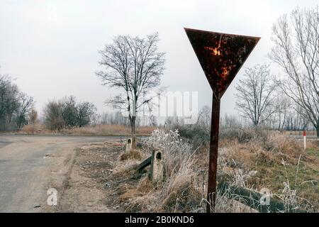 Ertragsanzeichen auf einer Winterstraße in der ungarischen Landschaft. Stockfoto