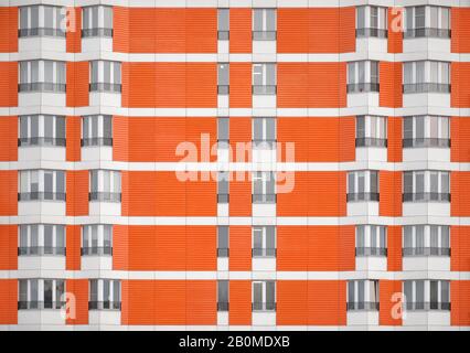 Viele Fenster in einem orangefarbenen Wohnhaus Stockfoto