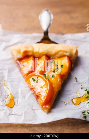 Pfirsichgalette, Kuchen, Kuchen auf einem Pergamentpapier. Holzhintergrund. Nahaufnahme. Stockfoto