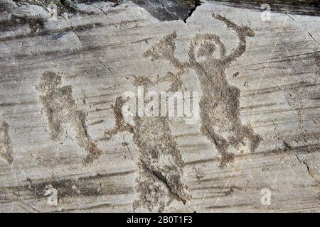 Petroglyph, Felsschnitzerei, von zwei Kriegern, die einen Helm tragen und ein Schwert und einen Schild tragen. Von den alten Camuni-Leuten in der Eisenzeit gehauen Stockfoto
