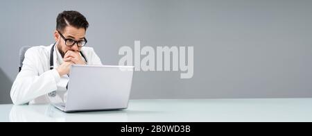 Trauriger Junger Männlicher Arzt Sitzt In Der Klinik Stockfoto