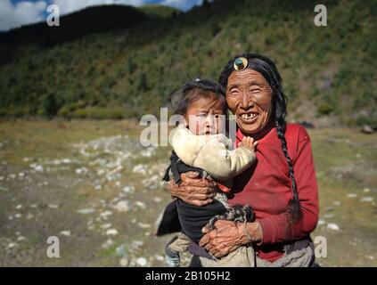 Tibetischen Familien halten zusammen. Während die Eltern arbeiten, Großeltern sind auf der Suche nach ihre Enkel. Remote tibetischen Plateau Stockfoto