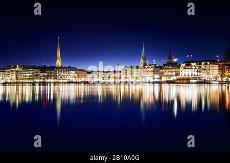 Die Promenade am Jungfernstieg spiegelt sich in der Alster zur blauen Stunde, Hamburg, wider Stockfoto