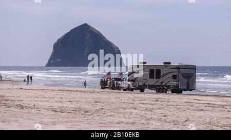 Pacific City, Oregon USA - 07. Juli 2019: Zwei Pickup-Trucks mit einem großen Wohnmobil-Anhänger, der an einem sonnigen Tag an einem Strand von Cape Kiwanda festsaß Stockfoto