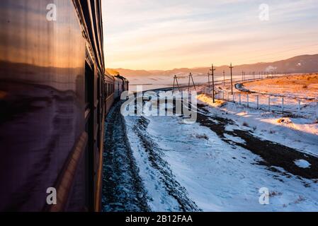 Transsibirische Eisenbahn während der Reise im Winter mit Sonnenuntergang Atmosphäre, Sibirien, Russland Stockfoto