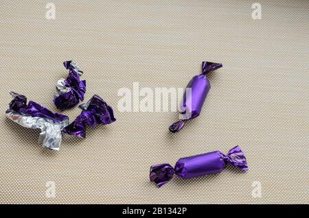 Die letzten unbeaten Leckereien und ein Haufen leerer Wrapper. Ansicht von oben. Nahaufnahme. Selektiver Fokus. Stockfoto