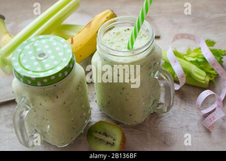 Gesunder grüner, gemischter Smoothie im Glasmaurerbecher. Mit Bananen, Kiwi, Sellerie. Diät-Konzept oder Entgiftungscocktail Stockfoto