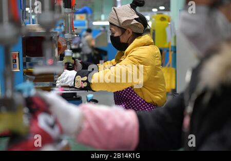 Nanchang, chinesische Provinz Jiangxi. Februar 2020. Arbeiter machen Schuhe in einer Schuhfabrik in der Stadt Xiangtang im Landkreis Nanchang, der ostchinesischen Provinz Jiangxi, 22. Februar 2020. Viele Unternehmen, die sich auf Exporte verlassen, haben die Produktion wieder aufgenommen. Kredit: Peng Zhaozhi/Xinhua/Alamy Live News Stockfoto