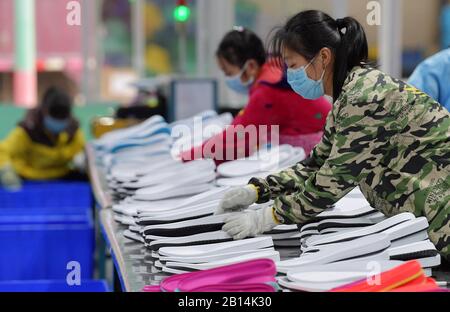 Nanchang, chinesische Provinz Jiangxi. Februar 2020. Arbeiter machen Schuhe in einer Schuhfabrik in der Stadt Xiangtang im Landkreis Nanchang, der ostchinesischen Provinz Jiangxi, 22. Februar 2020. Viele Unternehmen, die sich auf Exporte verlassen, haben die Produktion wieder aufgenommen. Kredit: Peng Zhaozhi/Xinhua/Alamy Live News Stockfoto