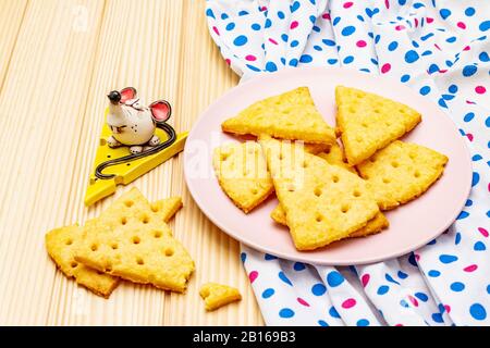 Lustige Kekse. Festliche Käsekrecker, Neujahrsnackkonzept. Essen, Mausskulptur, Serviette. Holzbohlen Hintergrund, Nahaufnahme Stockfoto