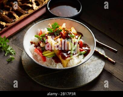 Schüssel mit chinesischem Reis mit Hühnerfleisch und verschiedenen Gemüse Stockfoto