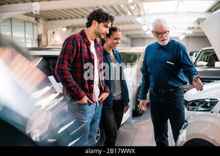 Auto Händler zeigen paar im showroom Stockfoto