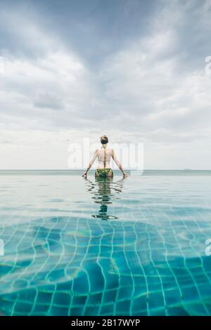 Rückansicht der Frau im Infinity Pool, Koh Lanta, Thailand Stockfoto