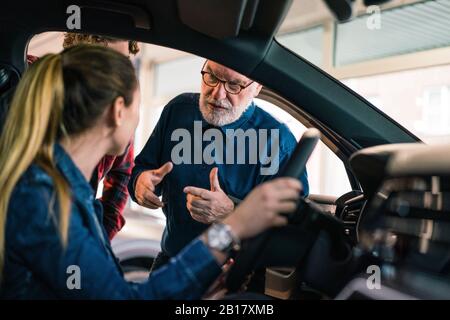 Auto Händler zeigen paar im showroom Stockfoto