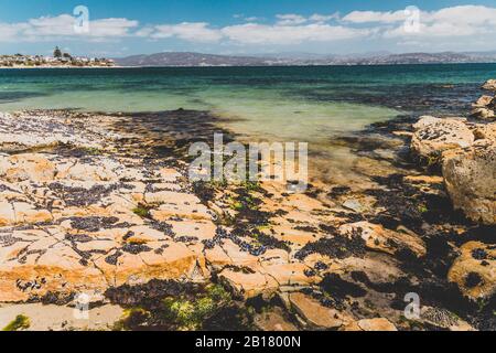 Opossum BAY, TASMANIEN - 16. Februar 2020: Landschaft in Opossum Bay Beach an einem sonnigen Sommertag mit niemandem am Strand mit tiefblauem Wasser und cl Stockfoto