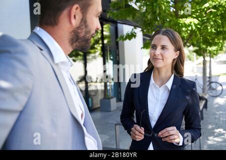 Unternehmer und Unternehmerin in der Stadt sprechen Stockfoto