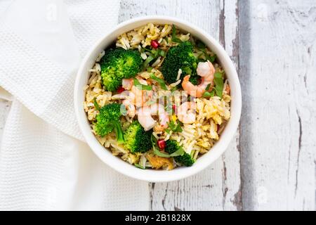 Gebratener Basmati-Reis mit Brokkoli und Garnelen, Chili, Koriander, Limette, Ingwer Stockfoto