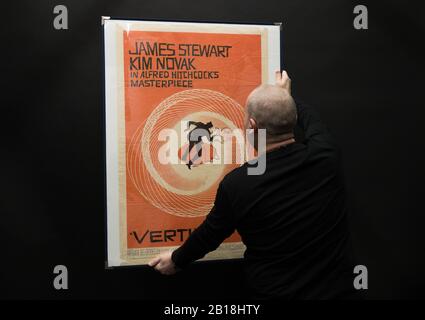 Der Prop Store Poster-Berater Mark Hochman hat sich am MONTAG, DEN 24. FEBRUAR, ein US One-Sheet-Poster für den Film "Vertigo" aus dem Jahr 1958 (Schätzung £1k - £2k) während einer Vorschau für die bevorstehende Kinoposter-Auktion des Prop Store anzusehen. Stockfoto