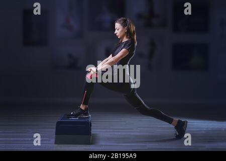 Frauen trainieren auf Stepper isoliert im Fitnessclub Stockfoto