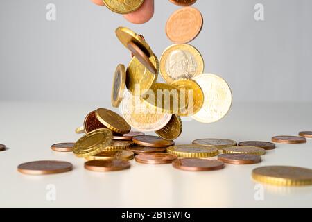 Euro-Münzen fallen auf einen Haufen. Geld, das vom Himmel über dem abstrakten Konzept regnet. Stockfoto