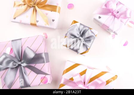 Set mit Geschenkschachteln mit Schleifen und Konfetti auf weißem Hintergrund. Stockfoto