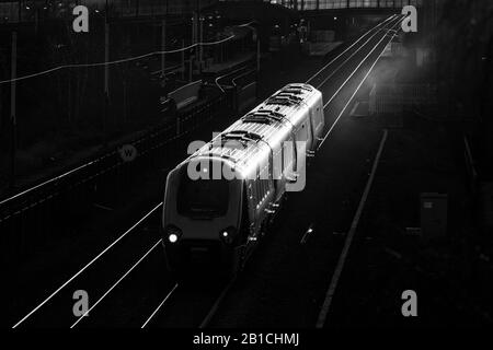 Cross-Rountry-Züge der Klasse 220 voyager fahren am Meadowhall Interchange, Sheffield Glinting in der untergehenden Sonne vorbei Stockfoto