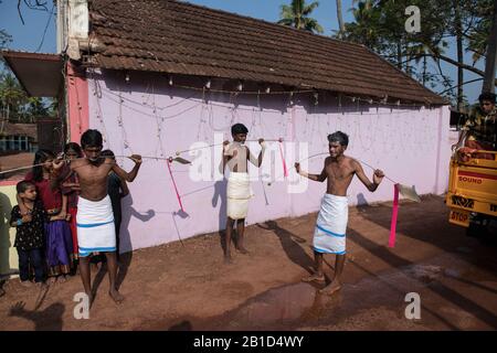 Anhänger, die Speere in ihren durchbohrten Mündern (Kavadi Aattam) als Akt der Hingabe während Thaipooyam oder Thaipoosam, Festival in Kedakulam, Kerala, halten. Stockfoto