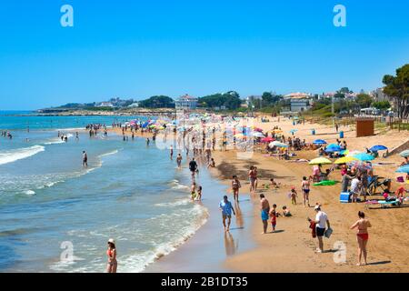 Alcossebre, SPANIEN - 11. JUNI 2017: Menschen, die das warme Wetter am Strand Playa del Cargador in Alcossebre an der Costa del Azahar in Spanien genießen Stockfoto