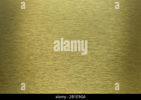 Hochwertiges Bild alter gebürsteter goldener Metalloberfläche mit hellem Reflexionshintergrund Stockfoto