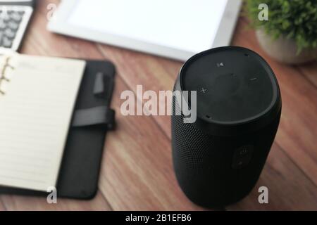 Nahaufnahme von Smart Speaker und Notizblock auf dem Schreibtisch Stockfoto