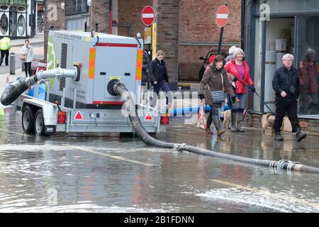 Shrewsbury, Shropshire, Großbritannien - Dienstag, 25. Februar 2020 - Käufer bewegen sich in der Innenstadt um Überschwemmungen, Pumpen und Rohre. Der Fluss Severn wird später heute seinen Höhepunkt erreichen, und für Shrewsbury gilt derzeit eine "Severn Flood Warning". Foto Steven May / Alamy Live News Stockfoto