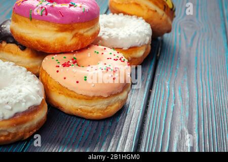 Glasierte Donuts auf Holzhintergrund. Kreatives Foto. Stockfoto