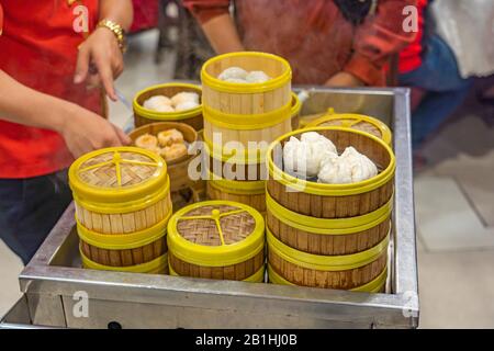 Kellnerin wählt Dimmsum Dampferbox für Kunden im chinesischen Restaurant Stockfoto